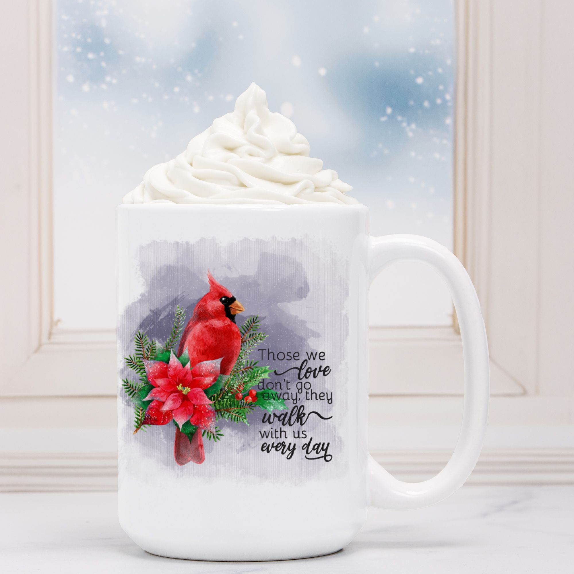 White mug with a red cardinal and poinsettia design, featuring a quote, against a snowy window background.