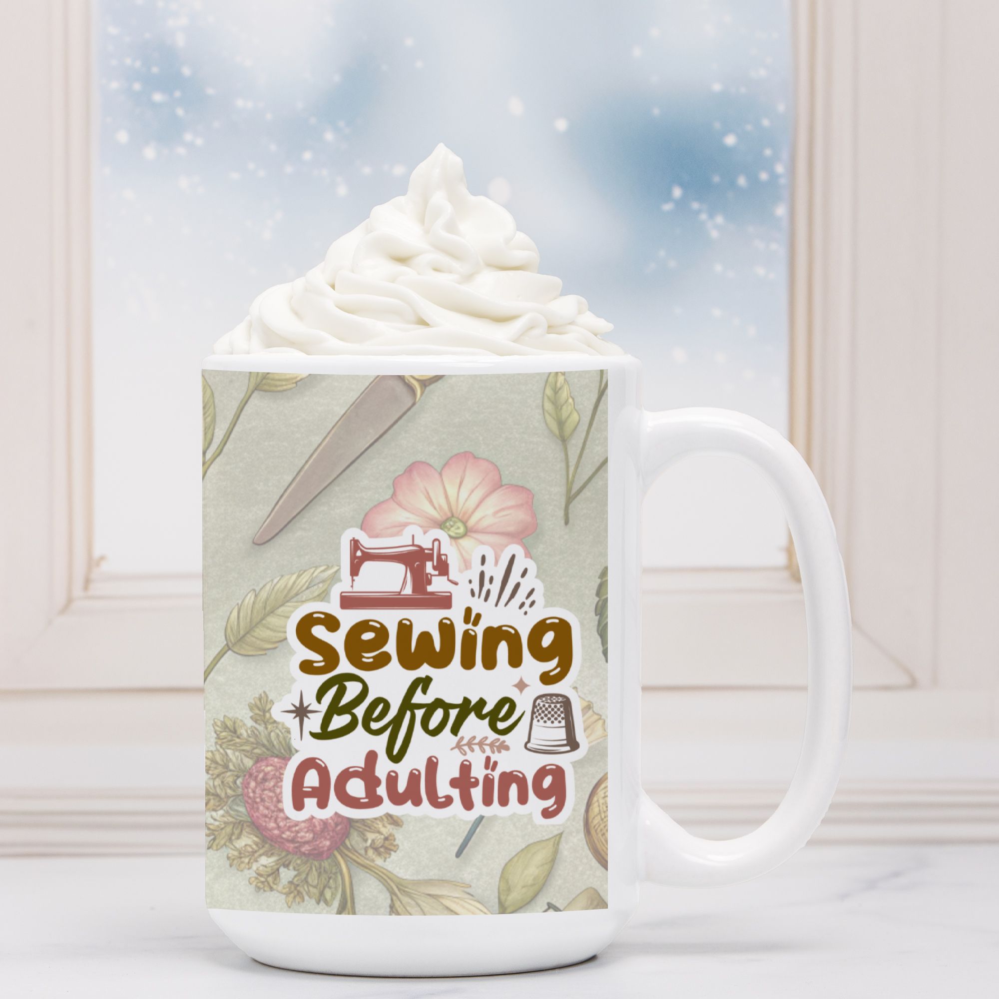 Mug with 'Sewing Before Adulting' design featuring sewing tools and flowers, topped with whipped cream.