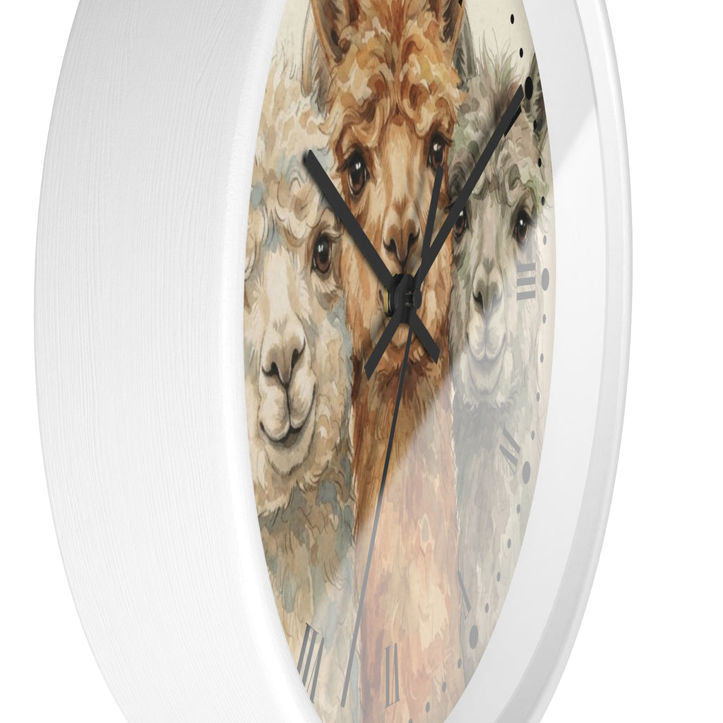 A round wall clock with a white textured frame and a printed face featuring three alpaca faces in soft beige, brown, and gray tones with black Roman numerals and black hands.