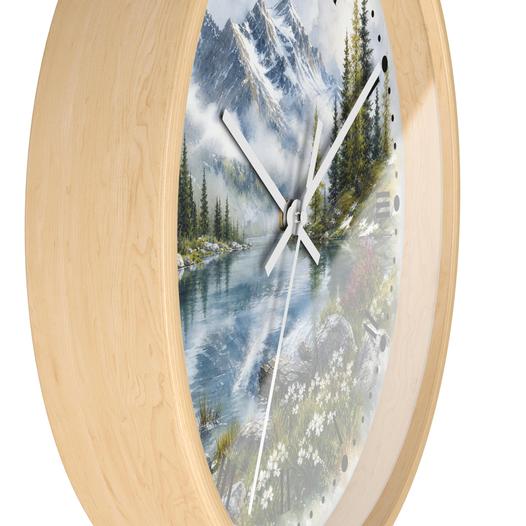 Round wall clock with a light natural wood frame and a scenic landscape print featuring a mountain lake, evergreen trees, and white flowers on the dial.