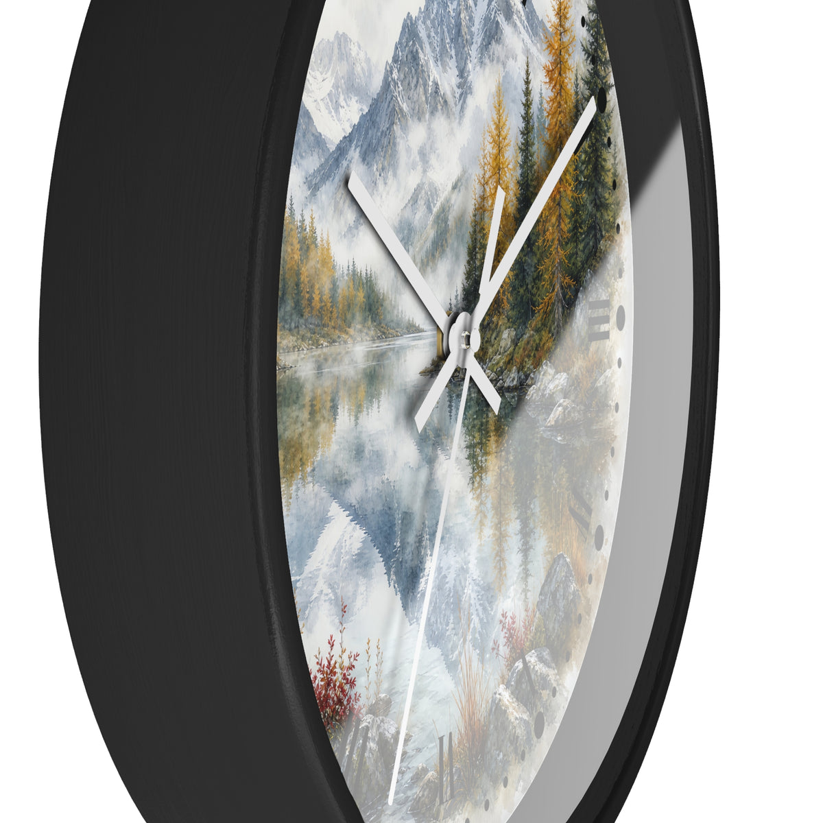 Round wall clock with a black frame and a scenic landscape print featuring snowy mountains, pine trees, and a reflective lake, shown against a white background.