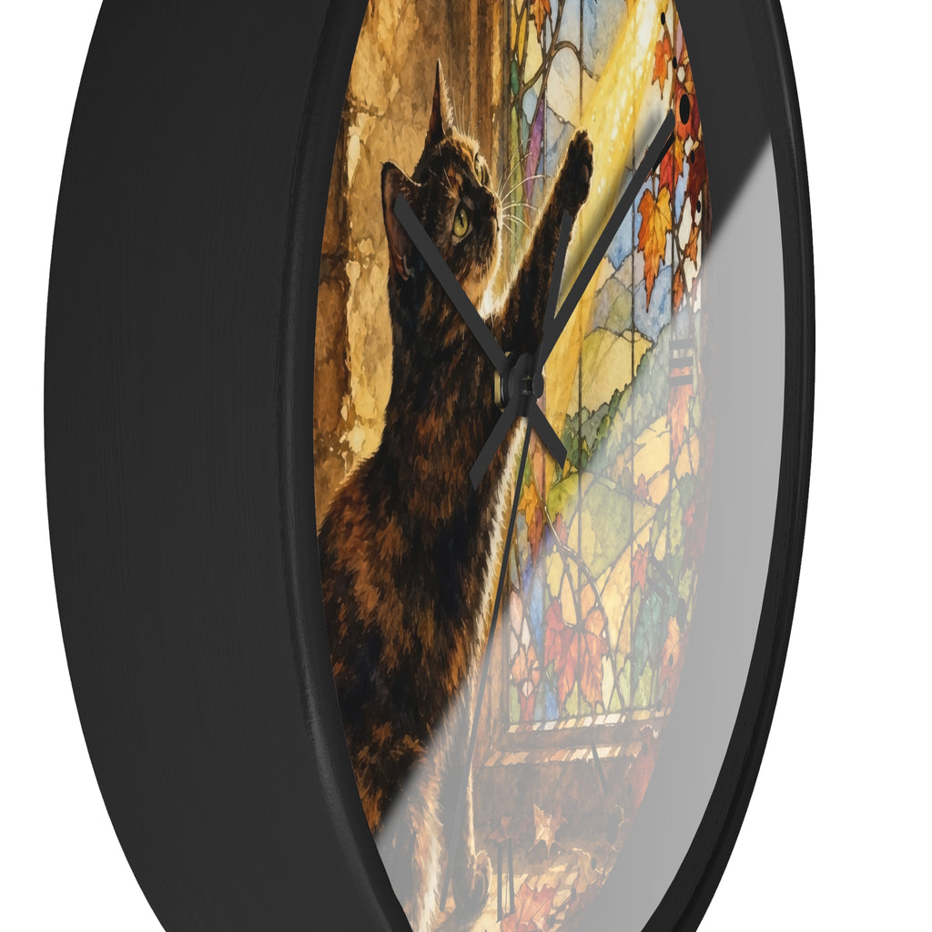 Round wall clock with a black frame and a printed design of a dark cat reaching toward colorful stained-glass windows, shown against a plain white background.