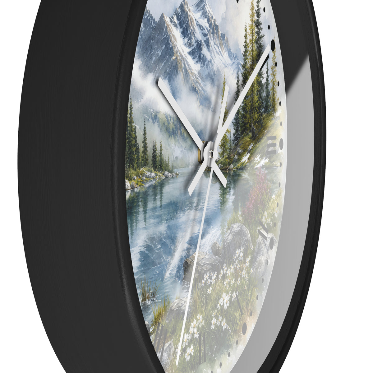 A round wall clock with a black frame and a scenic landscape print featuring a mountain lake, pine trees, and white flowers on the dial.