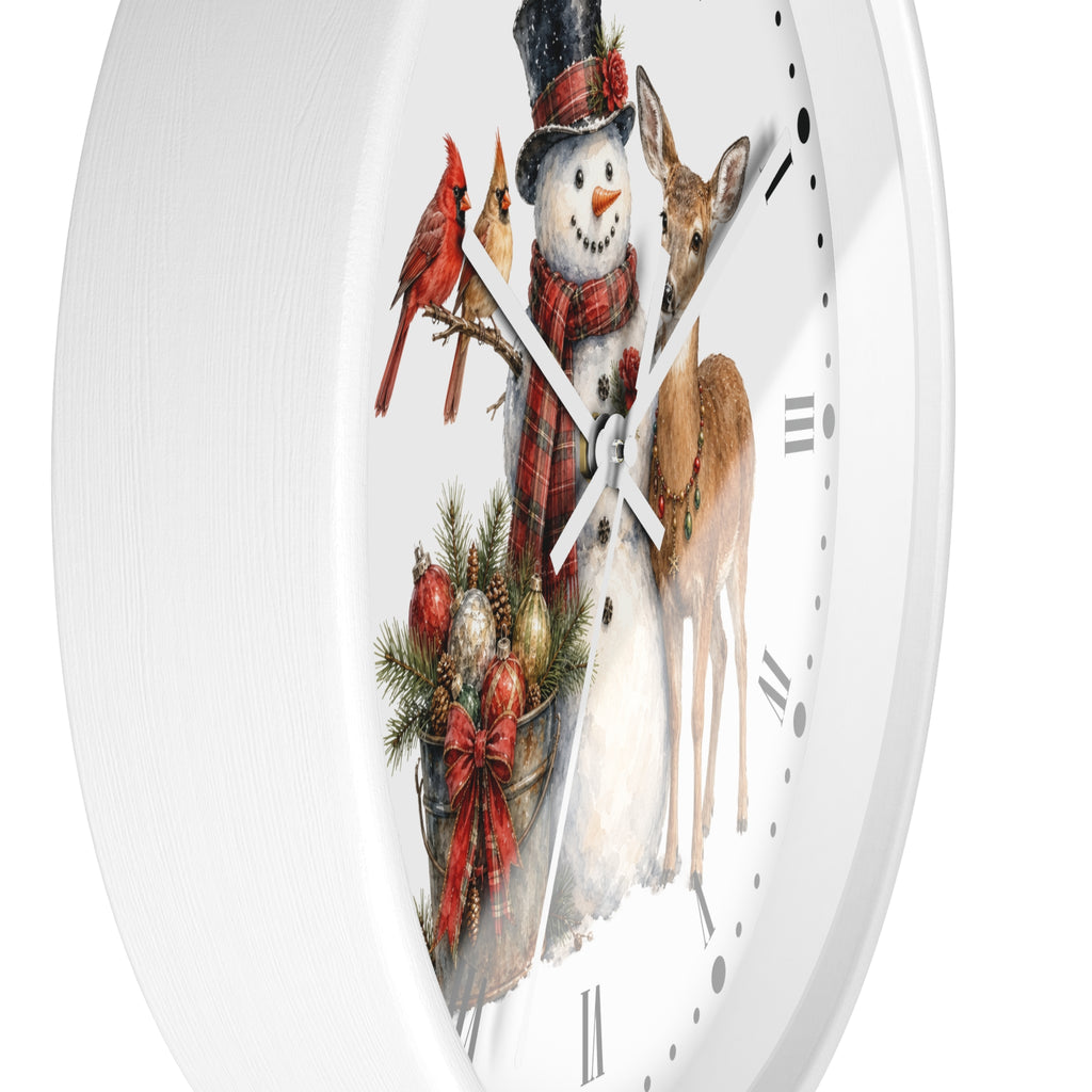 A white round wall clock with a festive Christmas illustration on the face, featuring a snowman in a plaid scarf and hat, two red cardinals, a deer, and holiday ornaments.