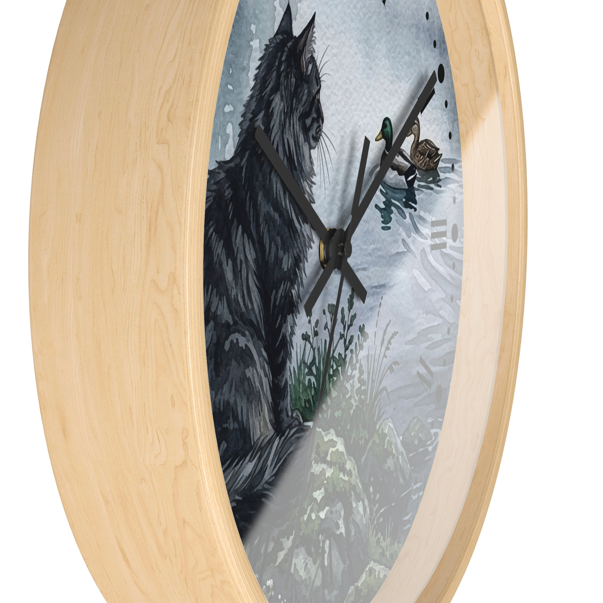Round wall clock with a light natural wood frame and a printed illustration of a black cat in a snowy outdoor scene on the clock face.