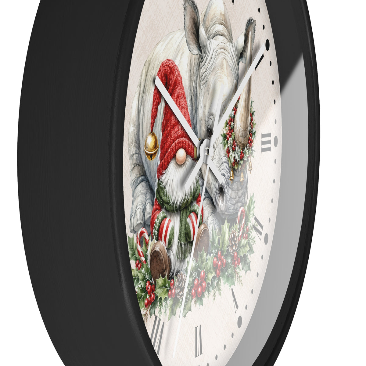 A round wall clock with a black frame and a white clock face featuring a festive illustration of a white rhinoceros with a gnome wearing a red Santa hat and green wreath, alongside a small gnome in a red hat and candy canes.