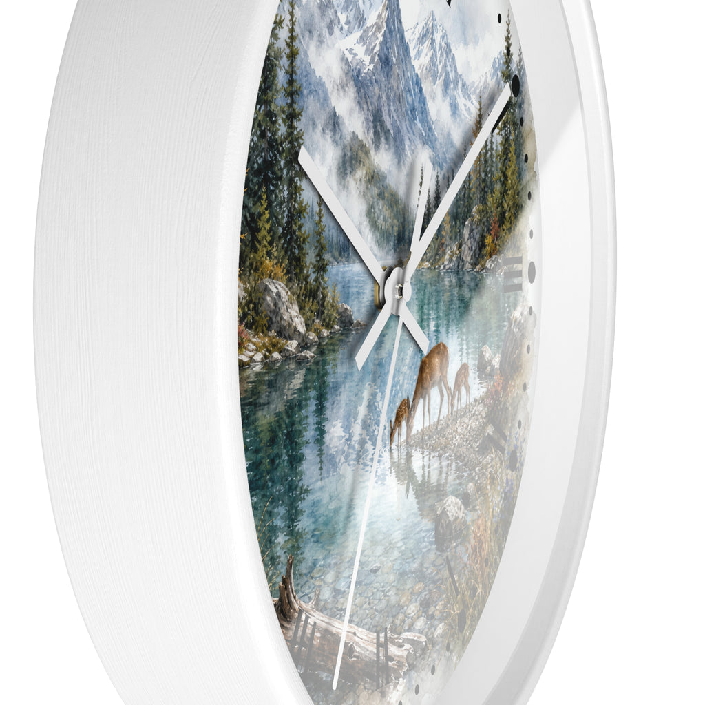 Round wall clock with a white frame and a scenic nature print featuring a mountain lake, evergreen trees, deer, and snowy peaks on the dial.