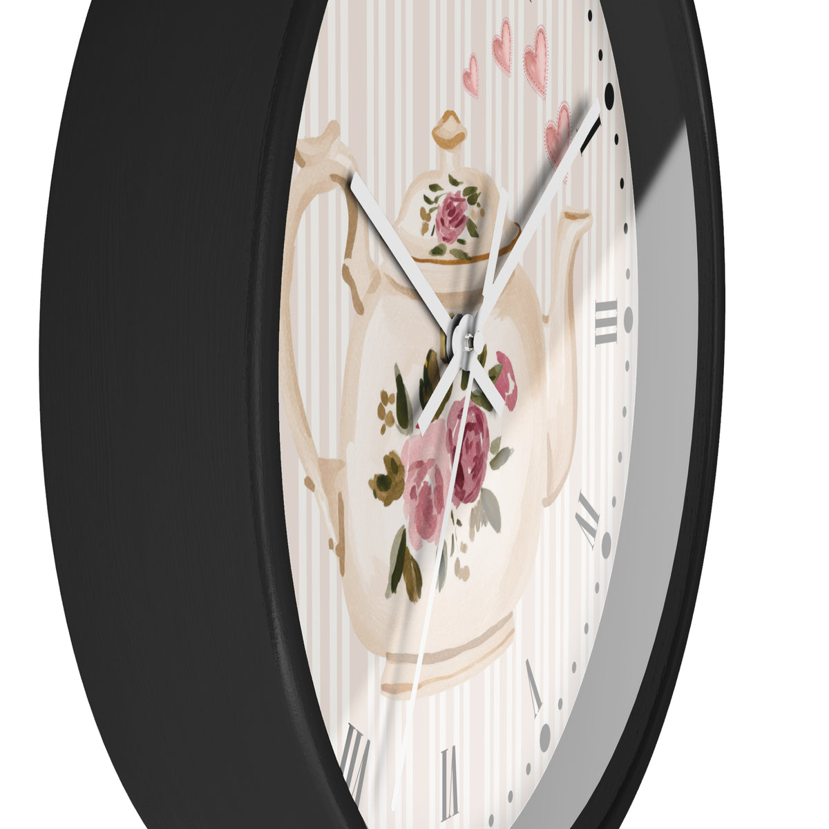 Round wall clock with a black frame and a white dial featuring a vintage floral teapot illustration and pink rose accents.