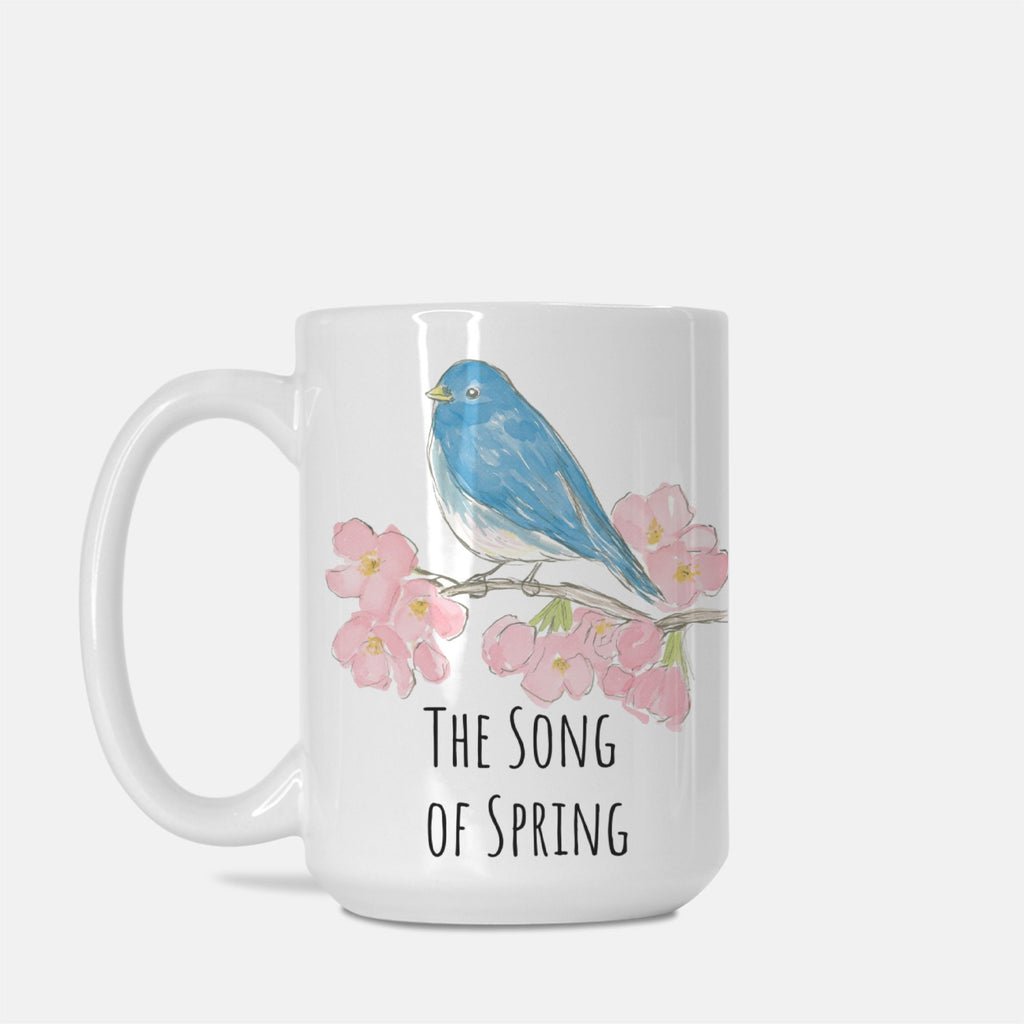 Mug with a blue bird and cherry blossoms design on a white background