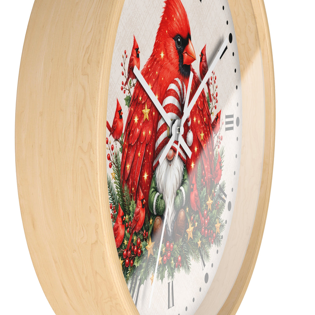 A round wall clock with a light natural wood frame and a white face featuring a festive Christmas design of red cardinals, a white-bearded gnome, evergreen branches, and holiday ornaments.
