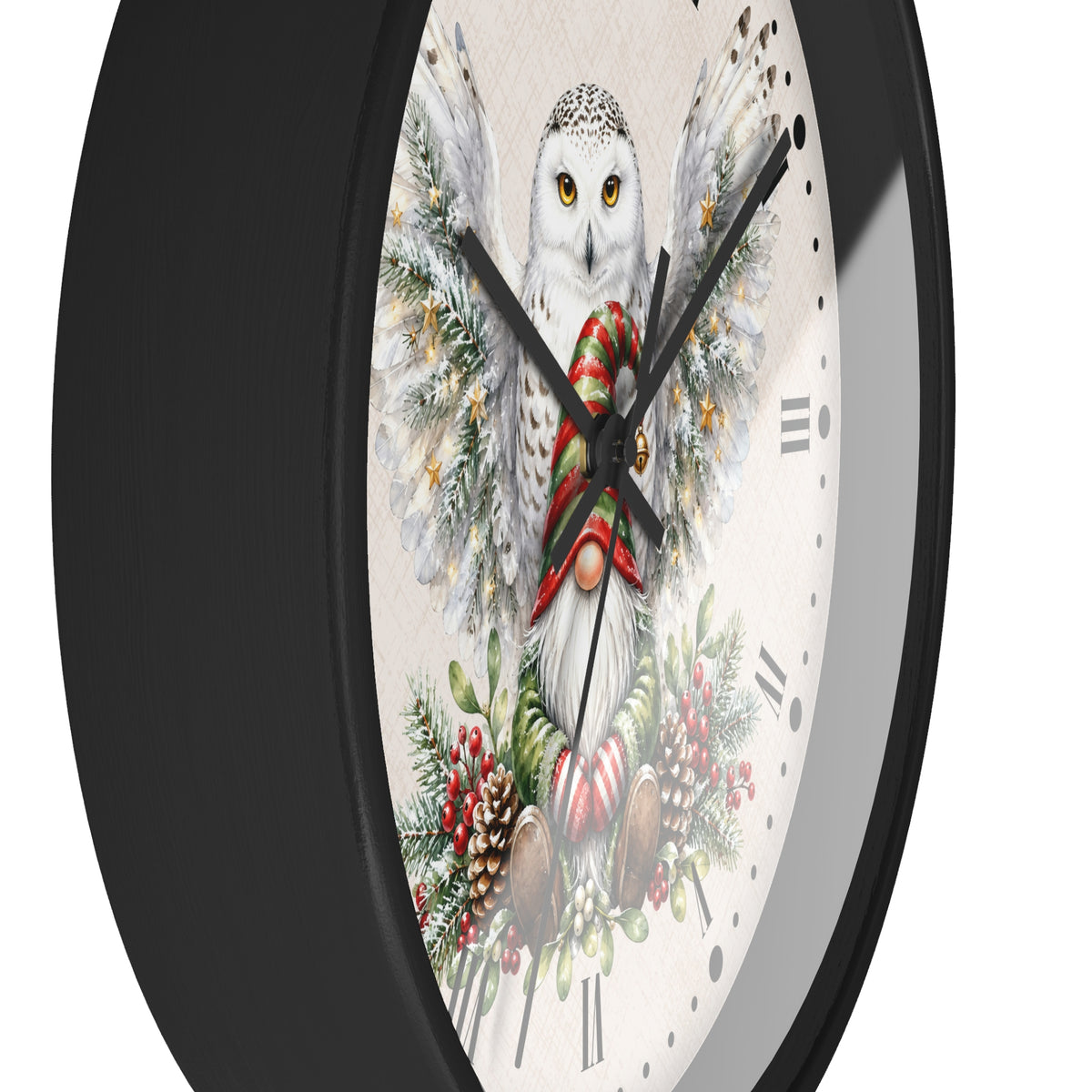 A close-up of a round wall clock with a black frame and a festive printed dial featuring a snowy owl, evergreen branches, pinecones, and red holiday accents on a white background.