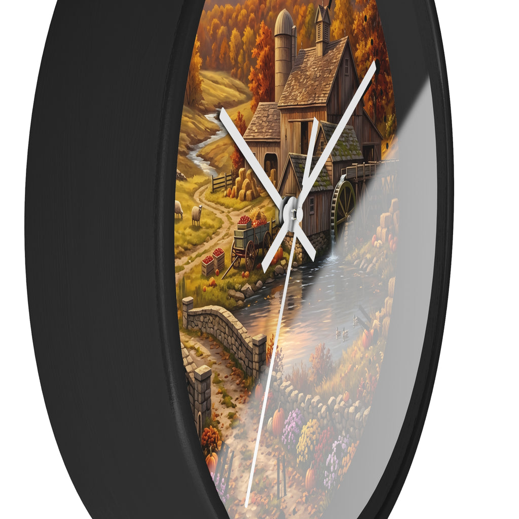 Round wall clock with a black frame and a printed scenic artwork of a rustic farm mill, water wheel, stone path, and autumn trees. White clock hands are visible against a white background.