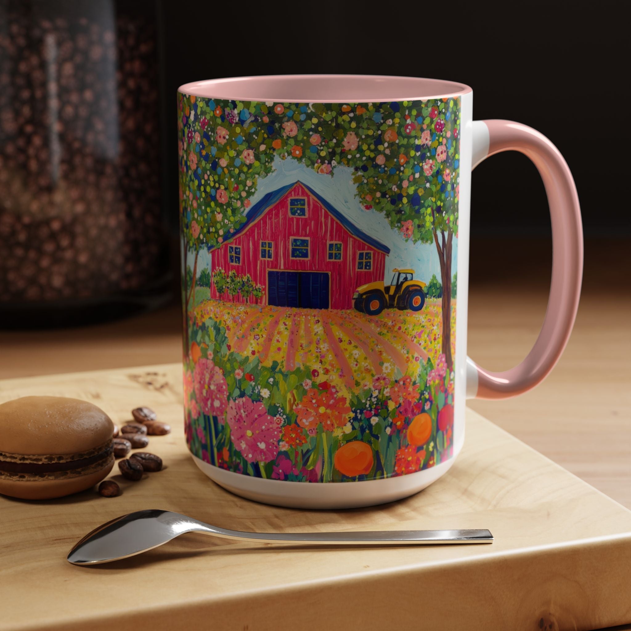 Colorful mug with a farm scene on a wooden table with coffee beans and a macaron.