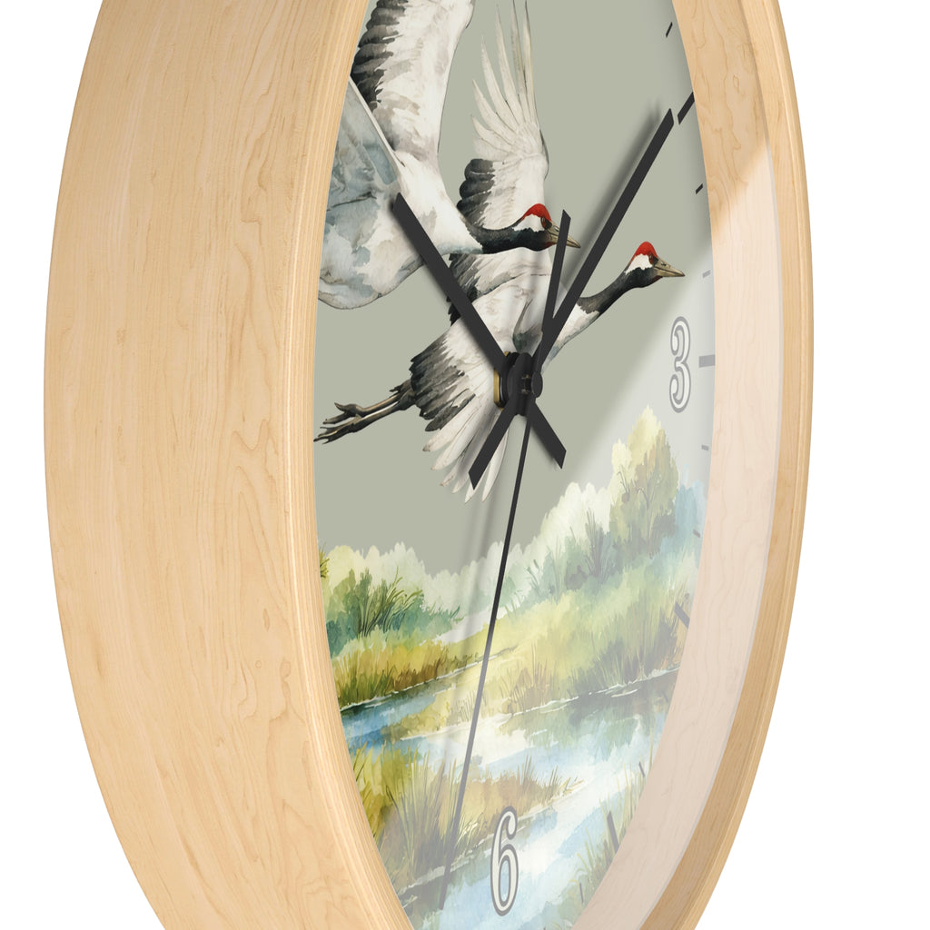 Round wall clock with a light natural wood frame and a printed dial featuring two flying cranes over a scenic landscape, shown on a white background.