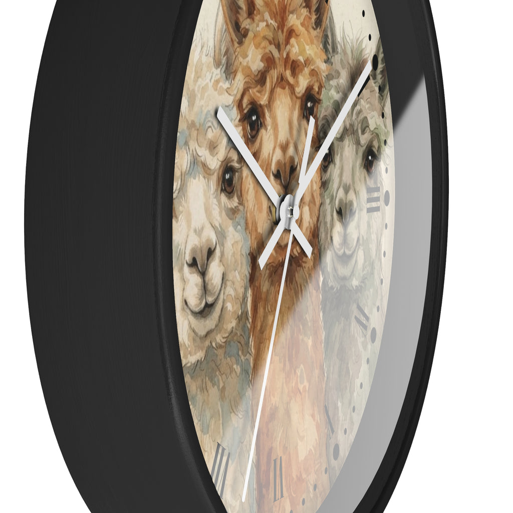 A round wall clock with a black frame and a printed face featuring three alpaca faces in soft beige, brown, and gray tones, with white clock hands and Roman numeral markers.