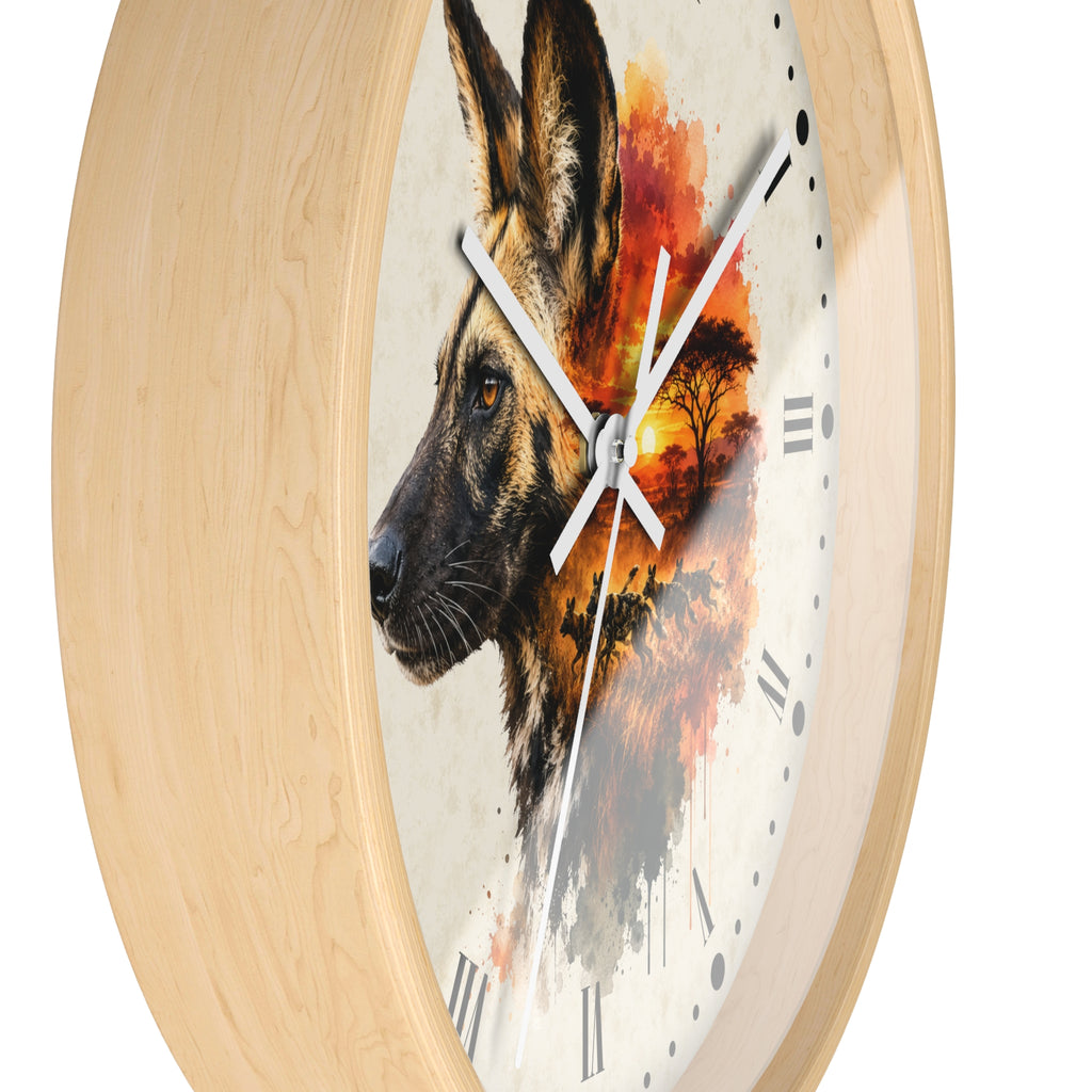 Round wall clock with a light natural wood frame and a printed dial featuring a wild dog portrait blended with an orange sunset landscape scene.