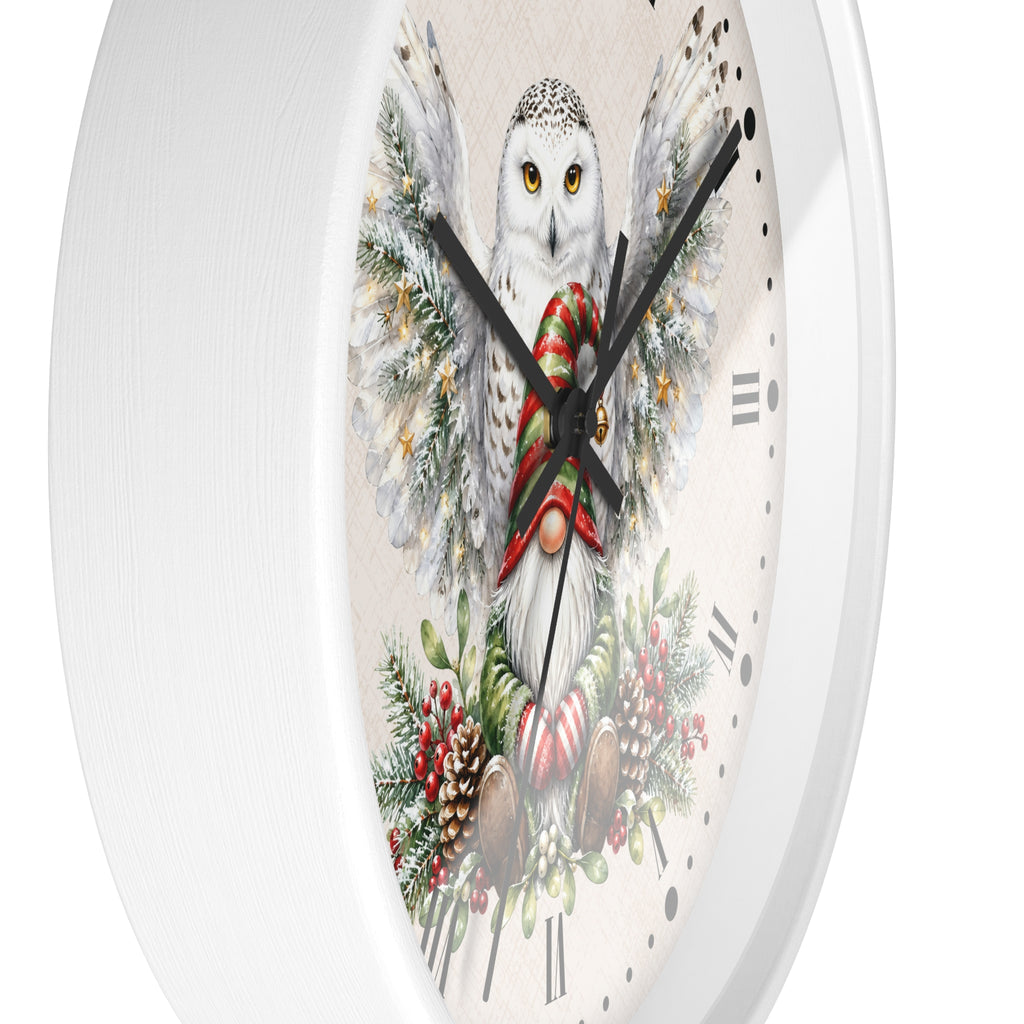 A white round wall clock with a festive Christmas owl illustration on the face. The design features a white owl with yellow eyes, wings decorated with snow and pine branches, a red and green striped scarf, candy canes, and holiday foliage.
