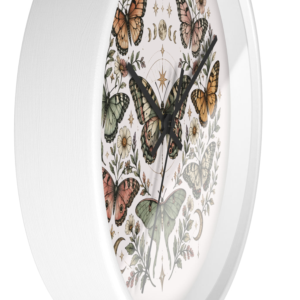 An oval wall clock with a white frame and a detailed vintage-style illustration of colorful butterflies and botanical elements on the face.
