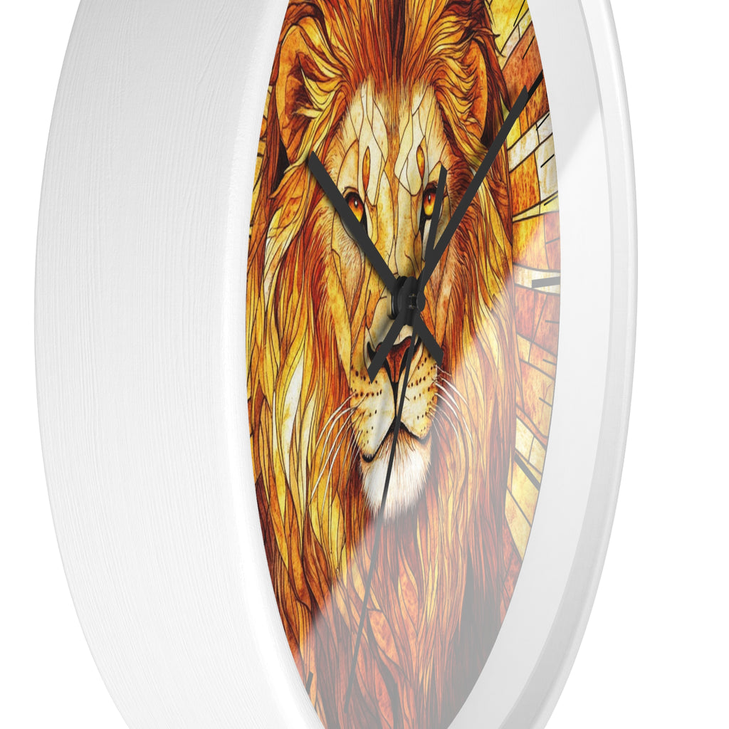 Round wall clock with a white frame and a printed lion face design in warm orange, yellow, and brown tones, with black hands on a white background.