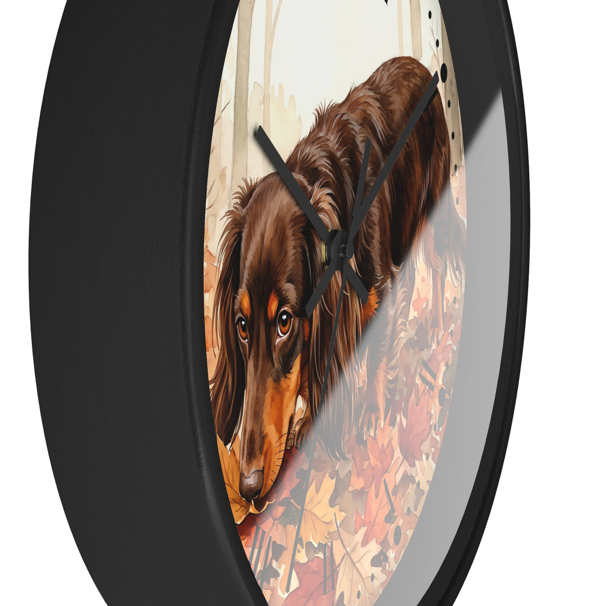 Round wall clock with a black frame and a printed illustration of a brown dachshund walking through autumn leaves, shown against a white background.