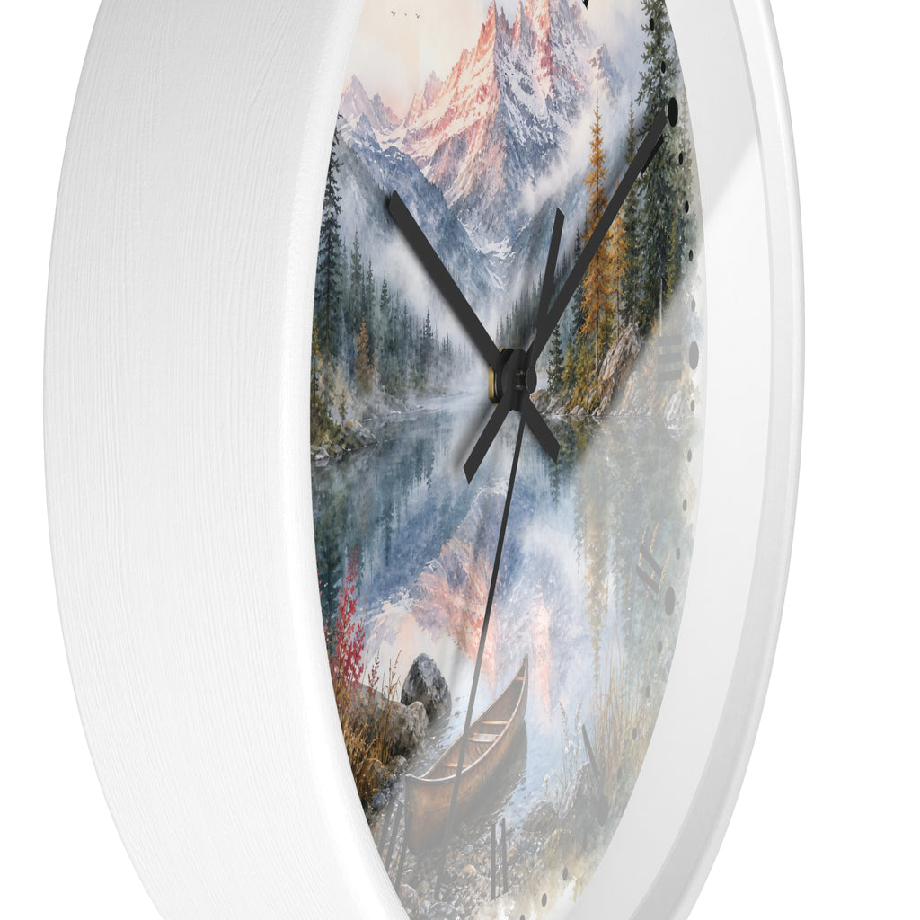 Round wall clock with a white frame and a scenic landscape print featuring snowy mountains, a misty lake, pine trees, and a canoe, shown against a plain white background.