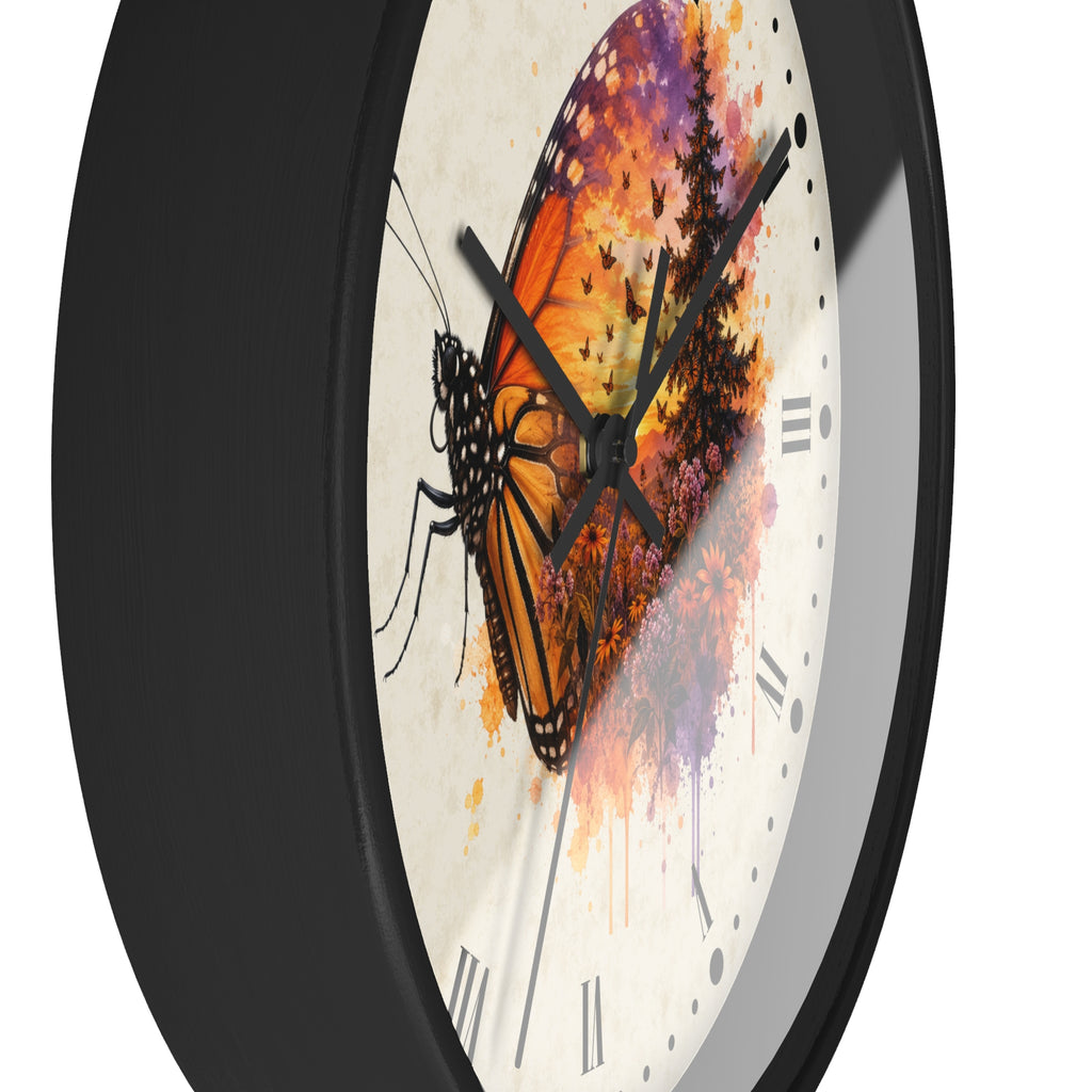 A close-up of a round wall clock with a black frame and a white face featuring a stylized butterfly and tree illustration in orange, purple, and black.