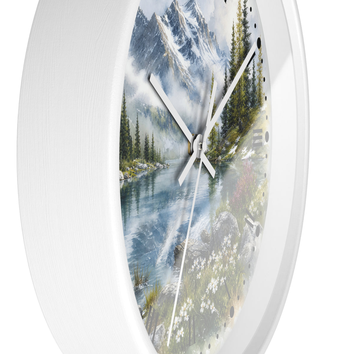 Round white wall clock with a scenic landscape print of a mountain lake, trees, and wildflowers on the face, shown against a white background.