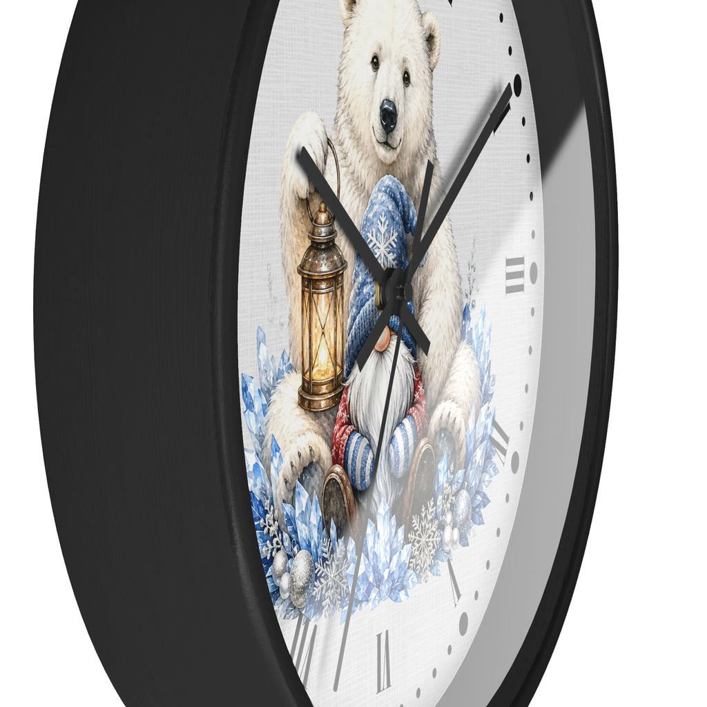 A round wall clock with a black frame and a white face featuring an illustration of a polar bear holding a lantern, surrounded by blue winter foliage. The clock is shown at an angle against a plain white background.