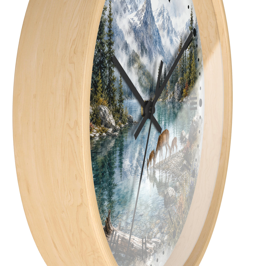 Round wall clock with a light natural wood frame and a scenic mountain lake print featuring deer on the dial, shown against a plain white background.