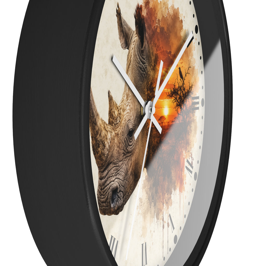 A round wall clock with a black frame and a printed face featuring a rhinoceros illustration over an orange sunset scene, shown against a plain white background.