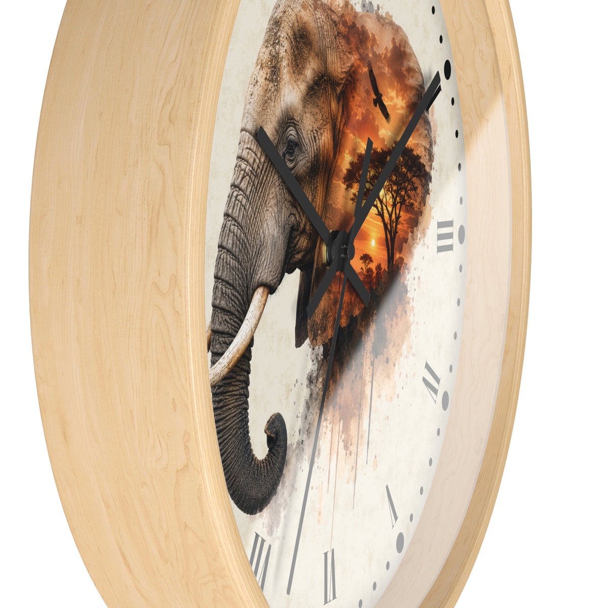 A close-up of a round wall clock with a light natural wood frame and a clock face featuring a painted elephant over an orange sunset landscape.