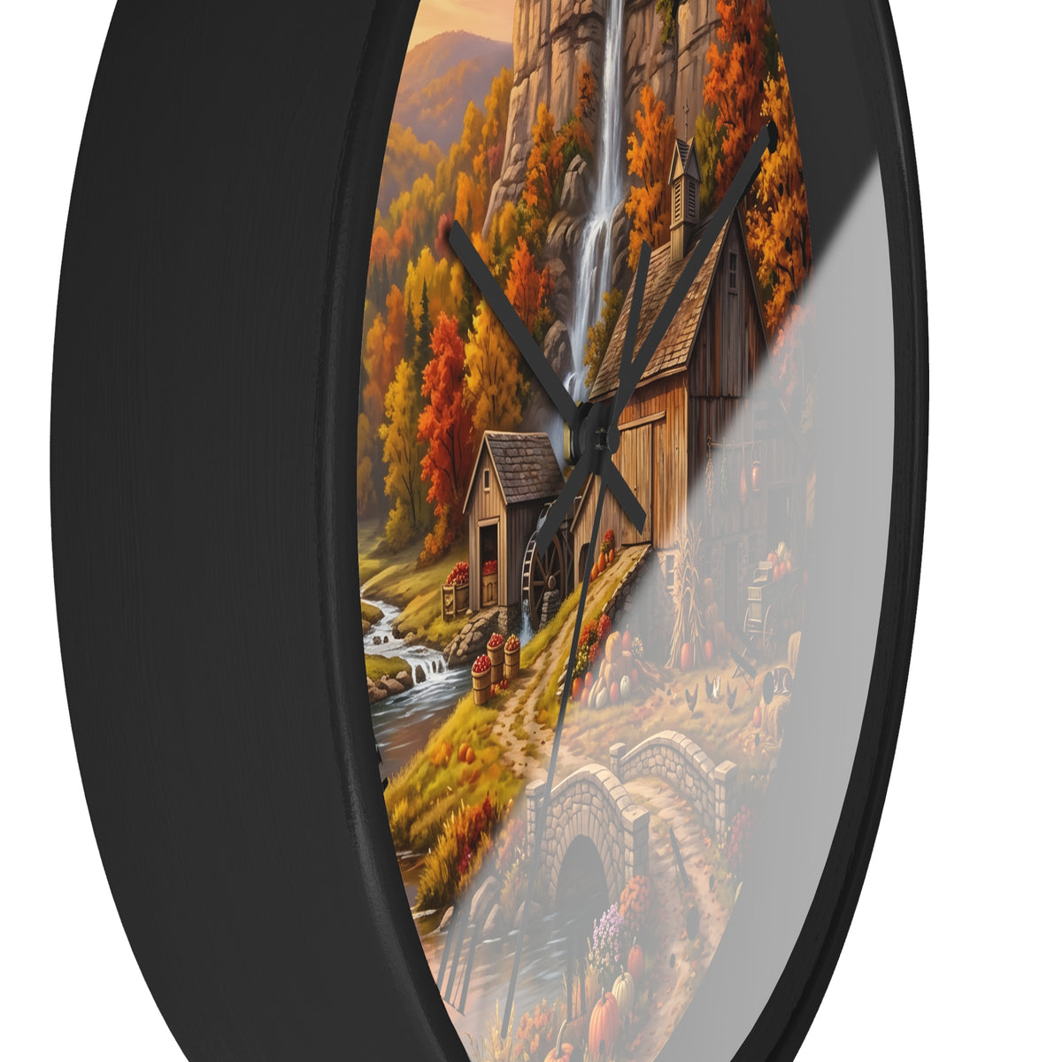 Round wall clock with a black frame and a scenic autumn landscape print featuring a waterfall, rustic mill, bridge, and colorful fall foliage.