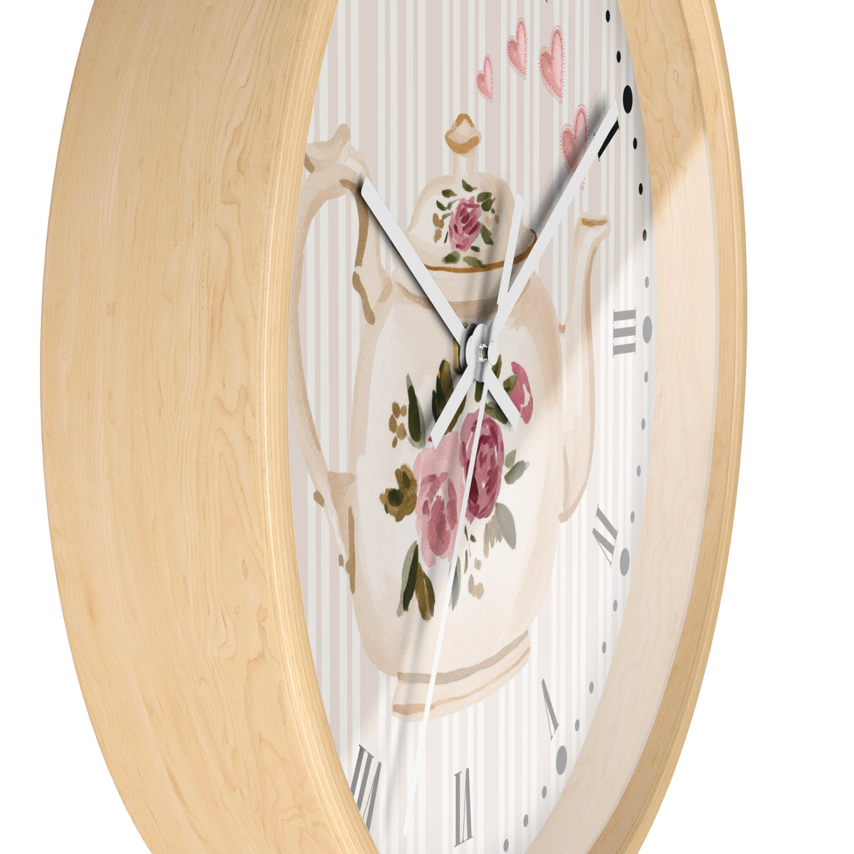 Round wall clock with a light natural wood frame and a white dial featuring a floral teapot illustration with pink roses and green leaves.