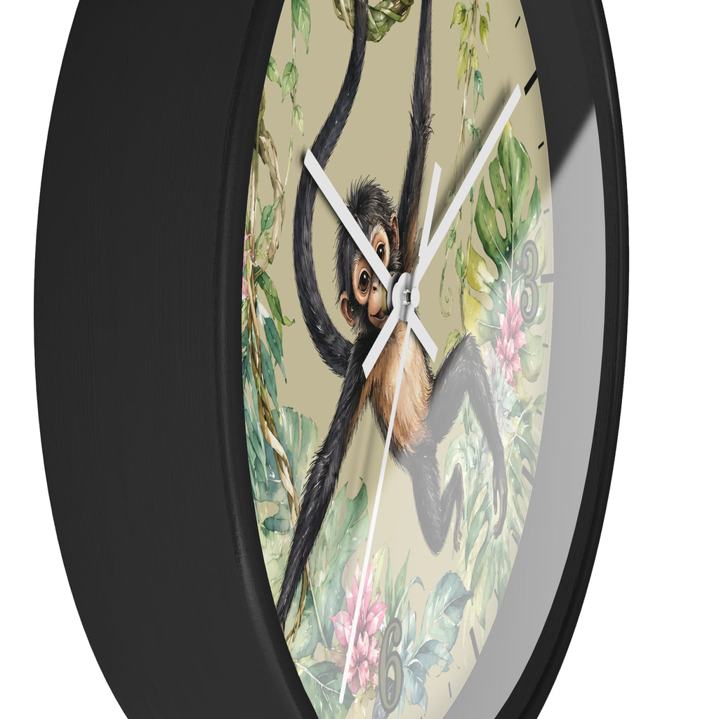 A round wall clock with a black frame and a vintage-style illustration of a chimpanzee hanging in the center, surrounded by tropical leaves and flowers on a light beige background.