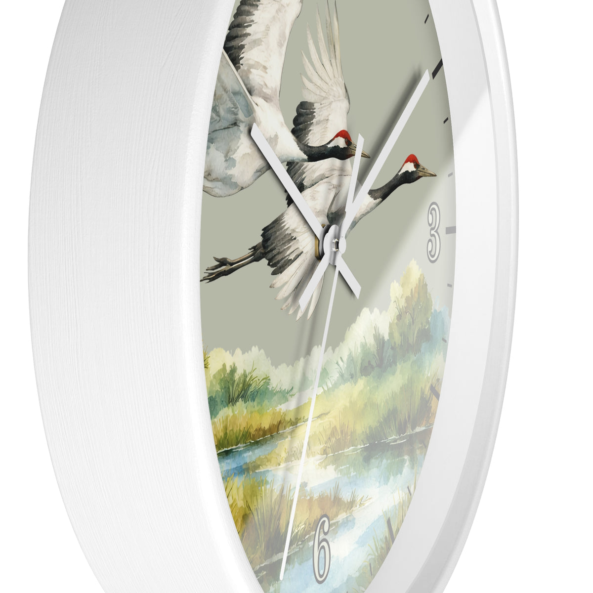 A white round wall clock with a detailed watercolor-style nature print featuring two flying cranes over a river landscape on the dial.