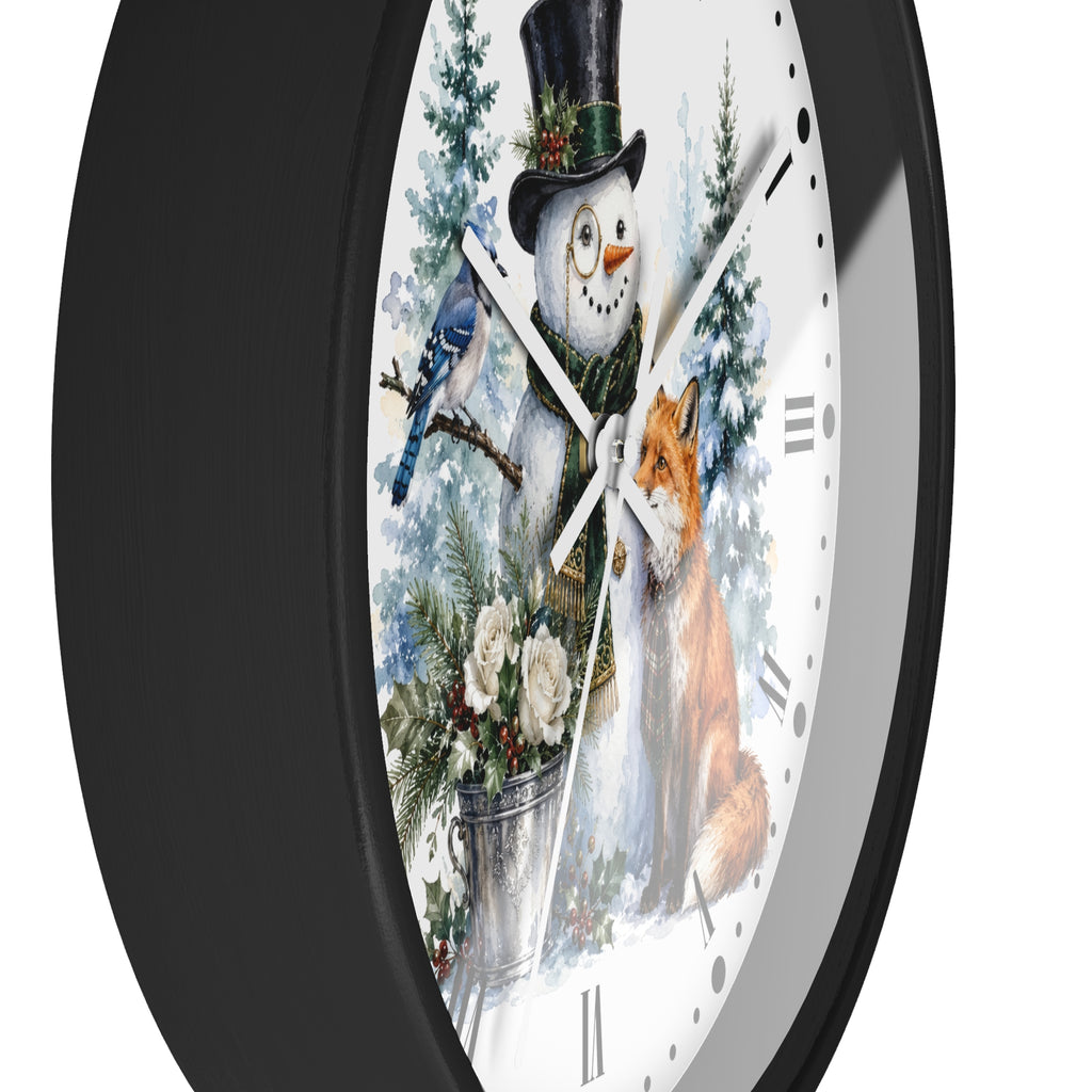 Round wall clock with a black frame and a white face featuring a winter holiday illustration of a snowman in a top hat, a bluebird, a fox, evergreen trees, and flowers.