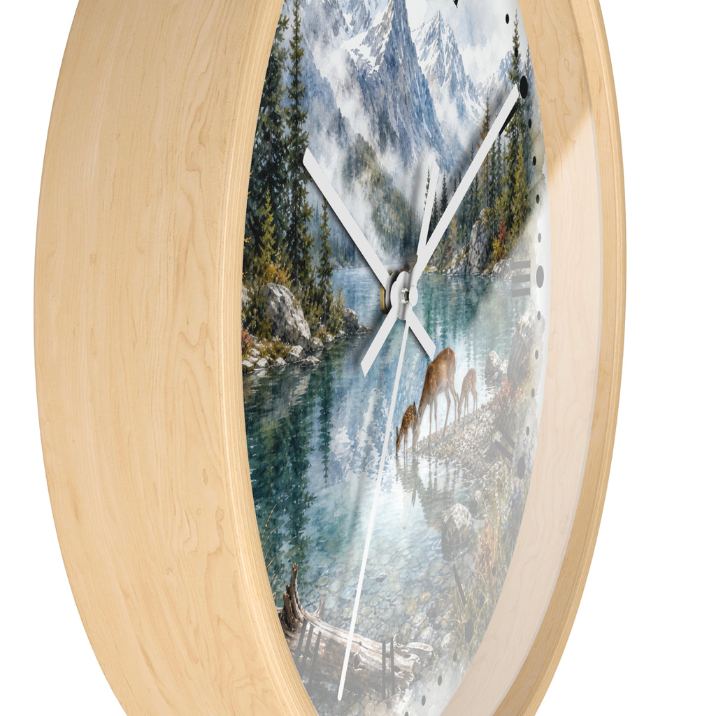 Round wall clock with a light natural wood frame and a scenic printed dial showing a mountain lake landscape with deer, photographed on a white background.