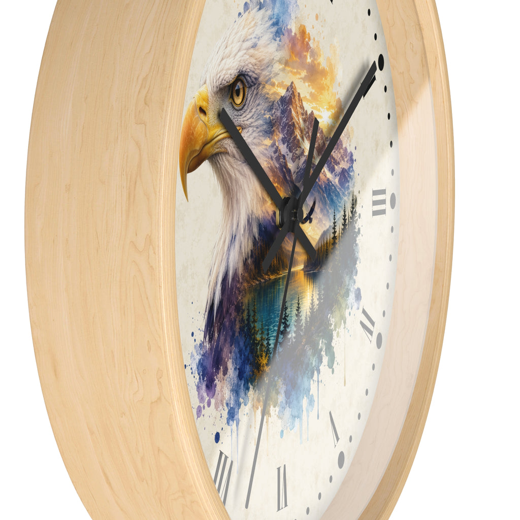 A round wall clock with a light natural wood frame and a white clock face featuring a watercolor-style bald eagle head with blue, purple, yellow, and orange painted details.