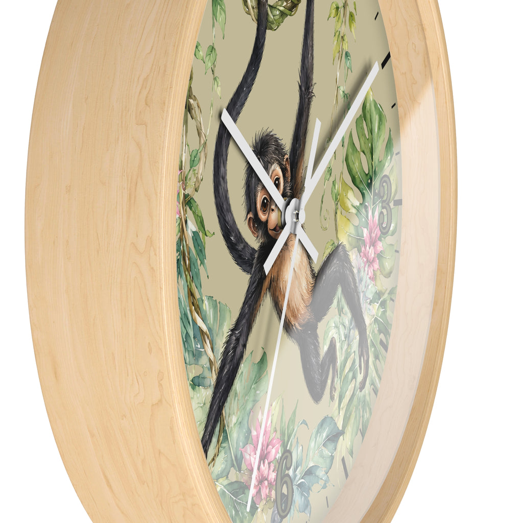 Round wall clock with a light natural wood frame and a central illustration of a chimpanzee hanging among green leaves and pink flowers on a pale beige background.