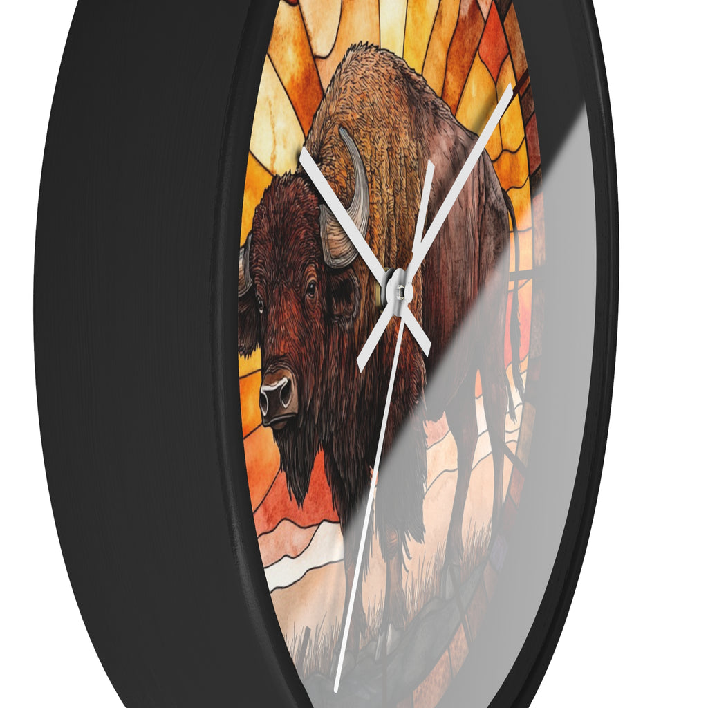 Round wall clock with a black frame and a stained-glass-style illustration of two bison in warm orange, yellow, and brown tones, shown against a white background.