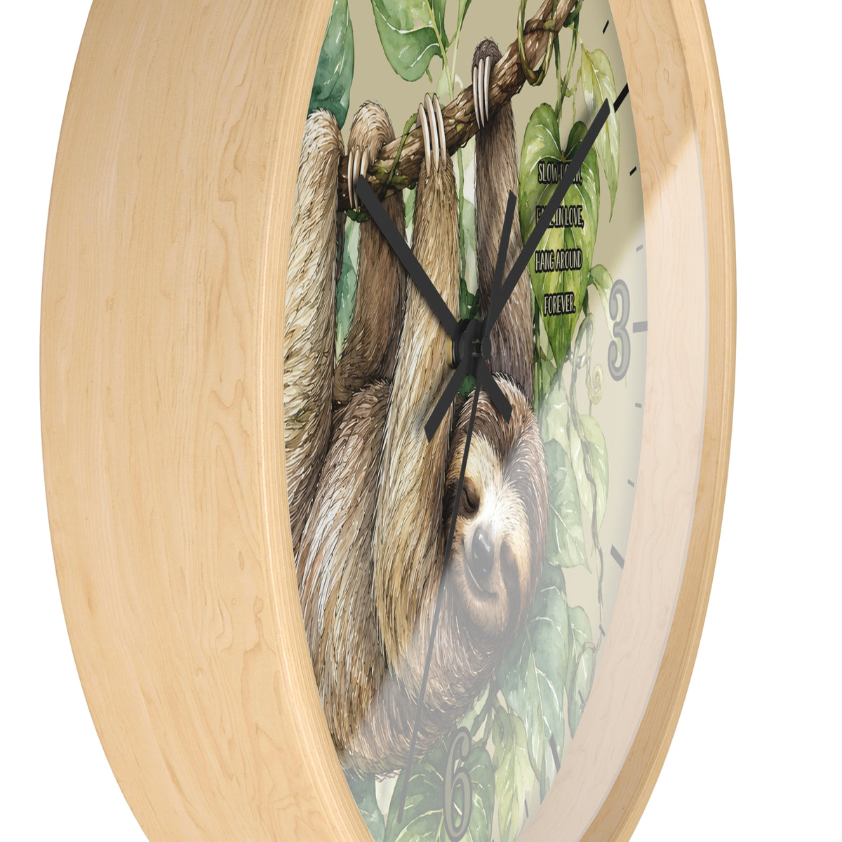 Round wall clock with a light natural wood frame and a printed backplate showing a sloth hanging among green leaves, with black hands and partial black numerals.