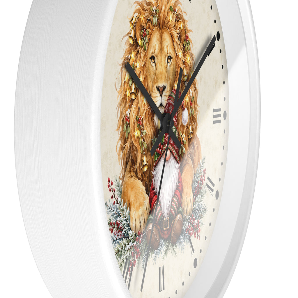 A white round wall clock featuring a festive illustration of a lion wearing a Christmas wreath and Santa hat on a cream dial with black Roman numerals and black hands.