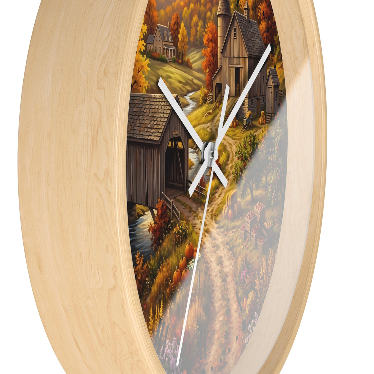 Round wall clock with a light natural wood frame and a printed autumn countryside scene on the face, featuring white clock hands and a thin second hand.