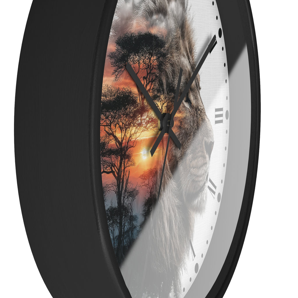 A close-up of a round wall clock with a black frame and a split design: one half shows a lion face, the other half shows an African savanna sunset with trees. The clock is shown against a plain white background.