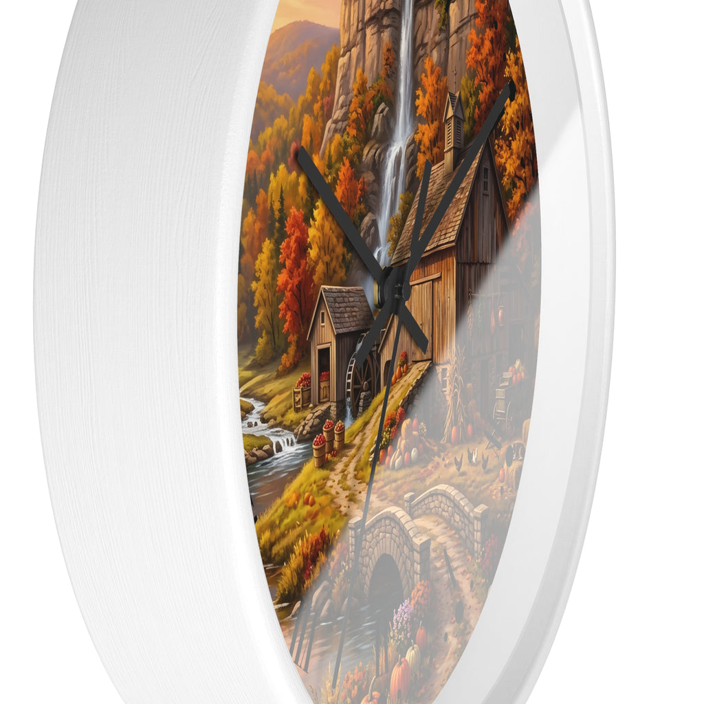 Round wall clock with a white frame and a scenic autumn landscape print featuring a waterfall, rustic mill, stream, and stone bridge.
