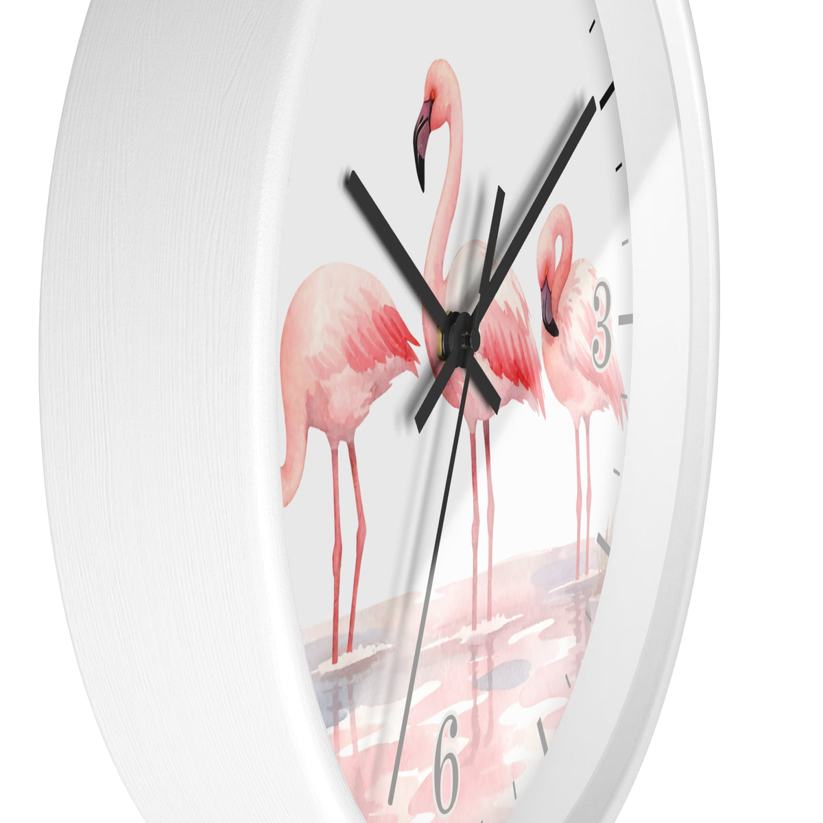 A white round wall clock with a printed design of three pink flamingos standing in shallow water, with black hands and gray numerals.