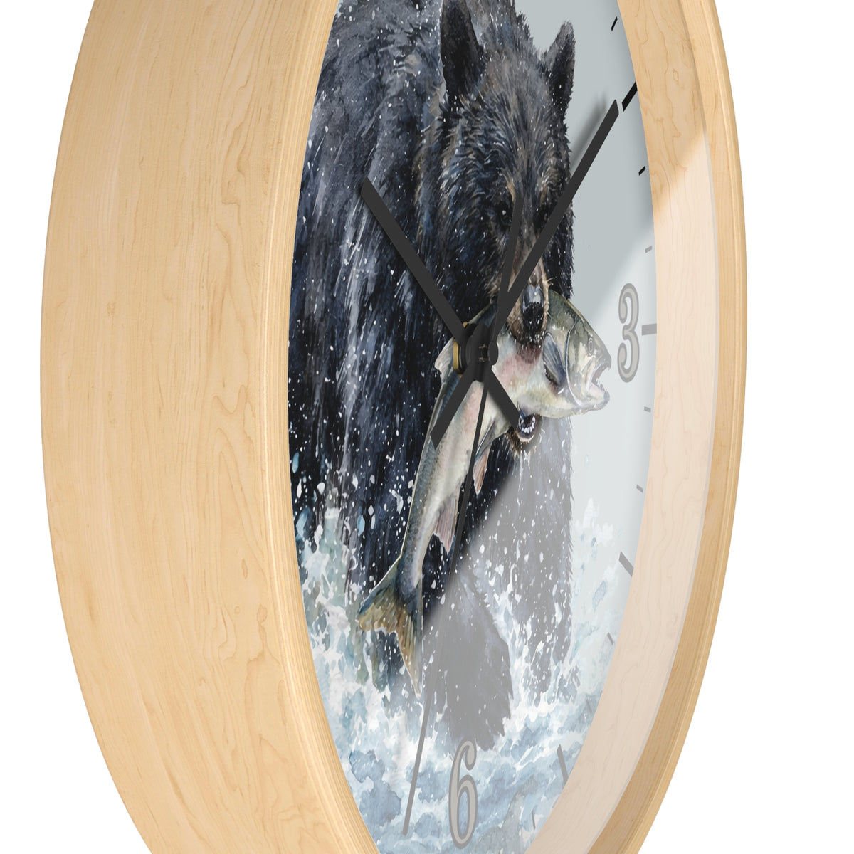 Round wall clock with a light natural wood frame and a printed dial showing a black bear catching a fish in splashing water, photographed on a white background.