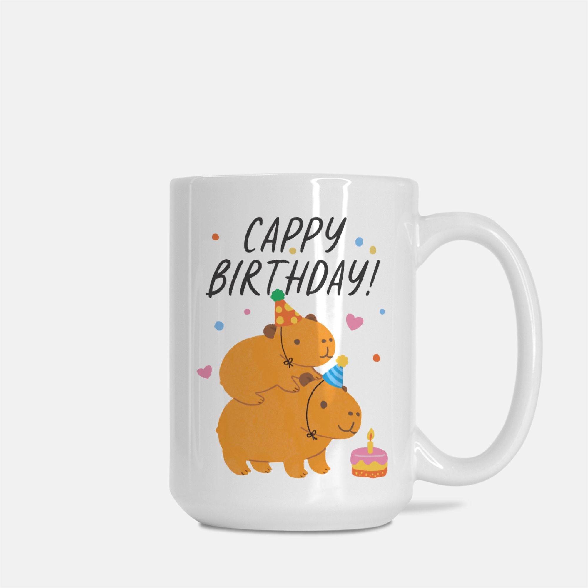 White mug with cartoon bears celebrating a birthday and 'Cappy Birthday!' text on a white background