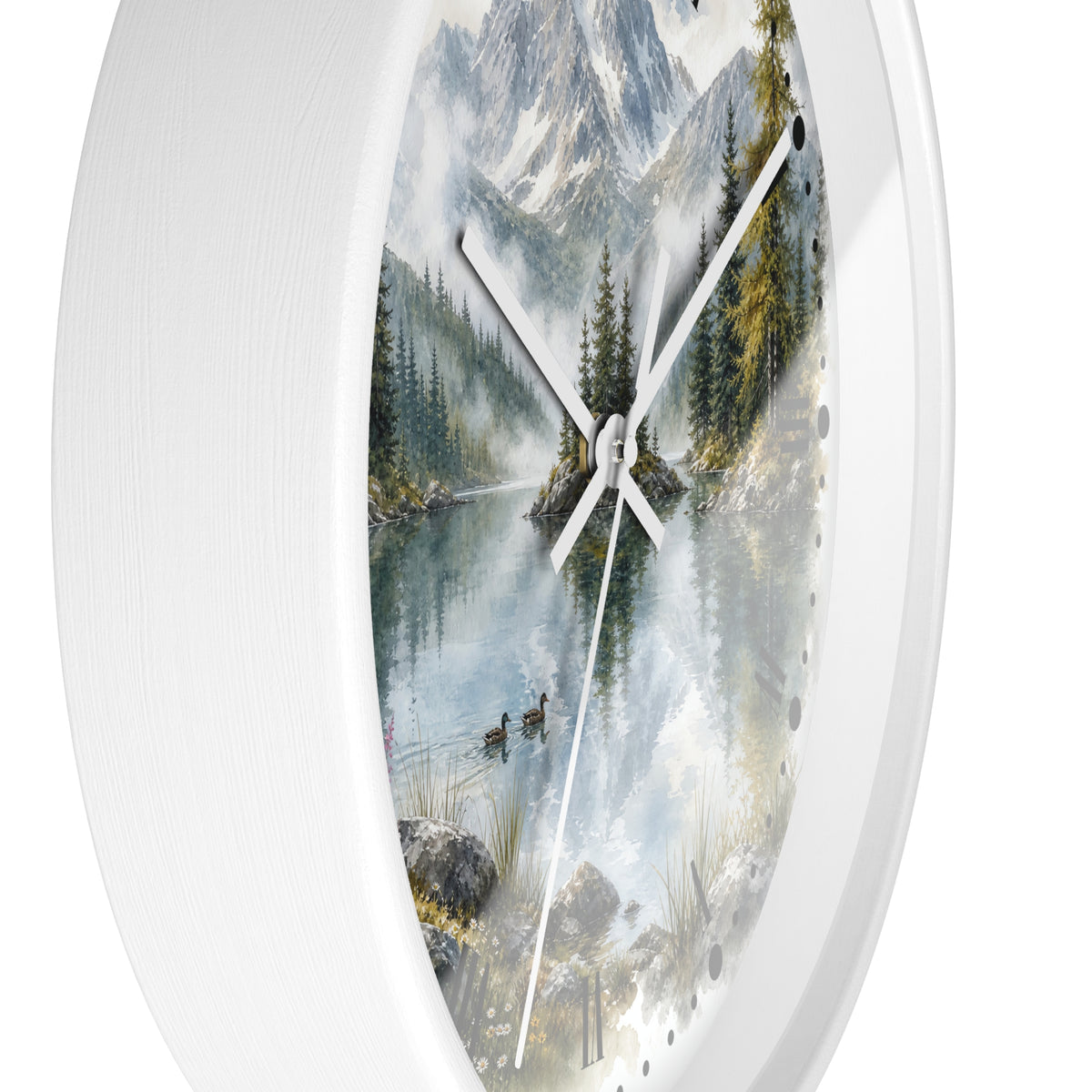 A round wall clock with a white textured frame and a scenic print of a mountain lake landscape featuring pine trees, ducks, and snowy peaks. The clock has white hands and is shown against a plain white background.