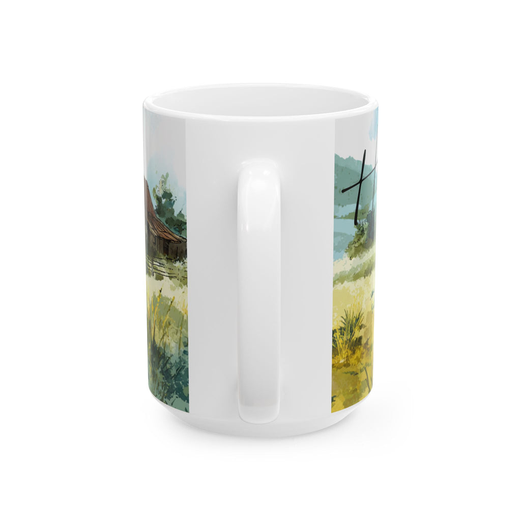 White mug with a scenic design of a field and house on a white background